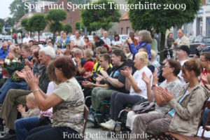 Das Bild zeigt einen Eindruck vom Spiel- und Sportfest Tangerhütte aus dem Jahr 2009. Das Publikum - teils im Rollstuhl - applaudiert.